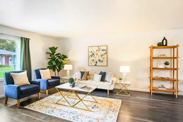 a living room with furniture and wooden floor