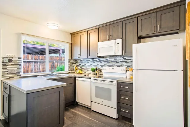 a kitchen with a white cabinets and white appliances