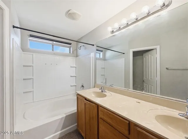 a bathroom with a sink mirror and a bathtub