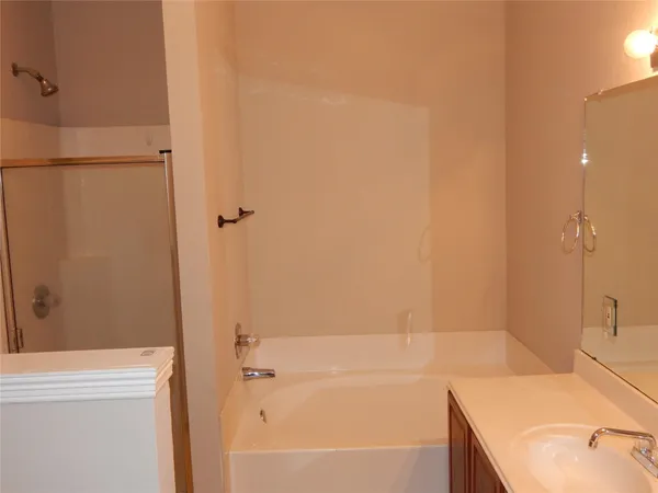 a bathroom with a tub and a sink