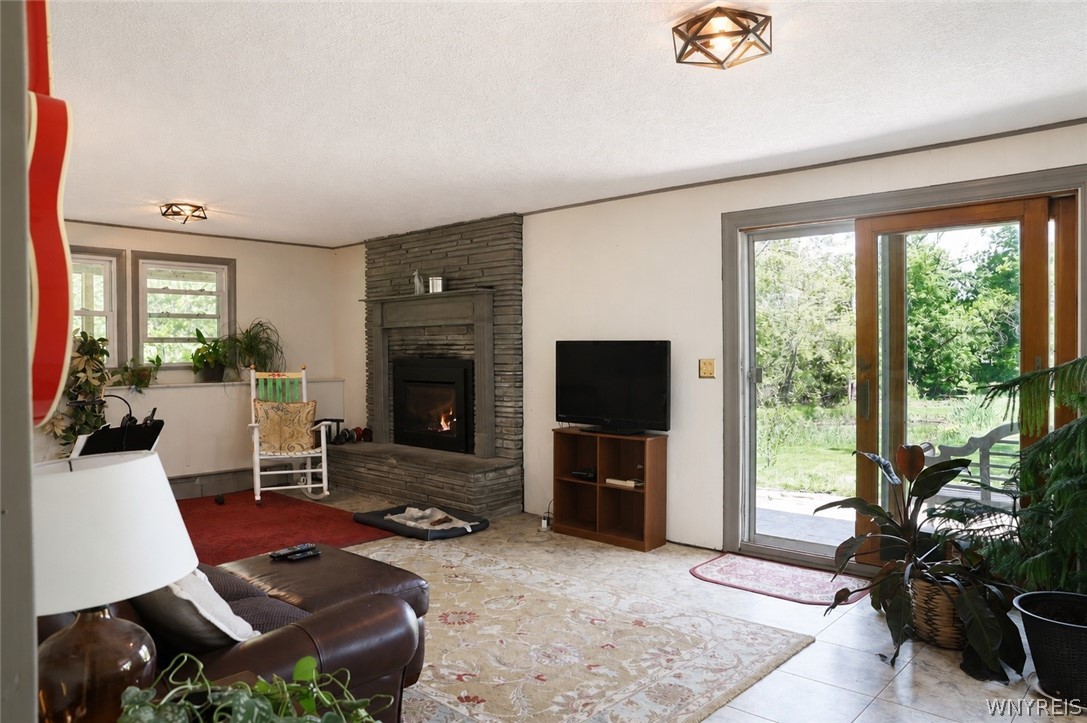 43 Hill Road Parma, NY 14468 - Photo 26 of 31 Downstairs living room and gas fireplace