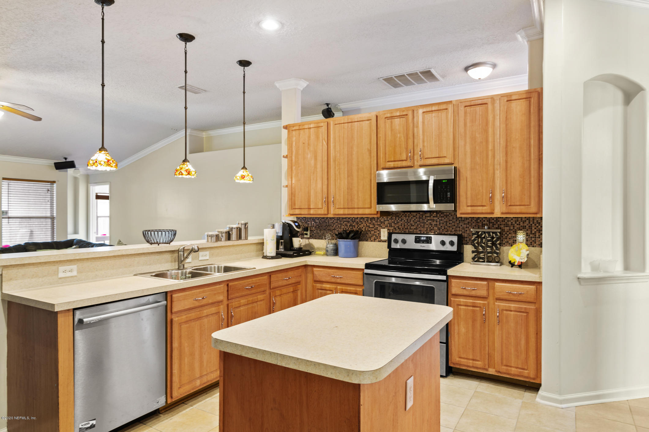8145 Leafcrest Drive Jacksonville, FL 32244 - Photo 11 of 25 a kitchen that has a sink a stove and a microwave