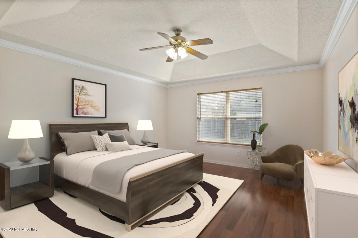 8145 Leafcrest Drive Jacksonville, FL 32244 - Photo 12 of 25 a bedroom with a bed and window