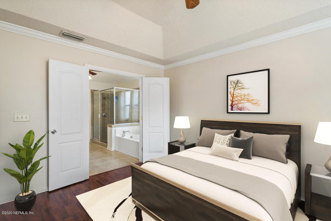 8145 Leafcrest Drive Jacksonville, FL 32244 - Photo 13 of 25 a bedroom with bed and a potted plant