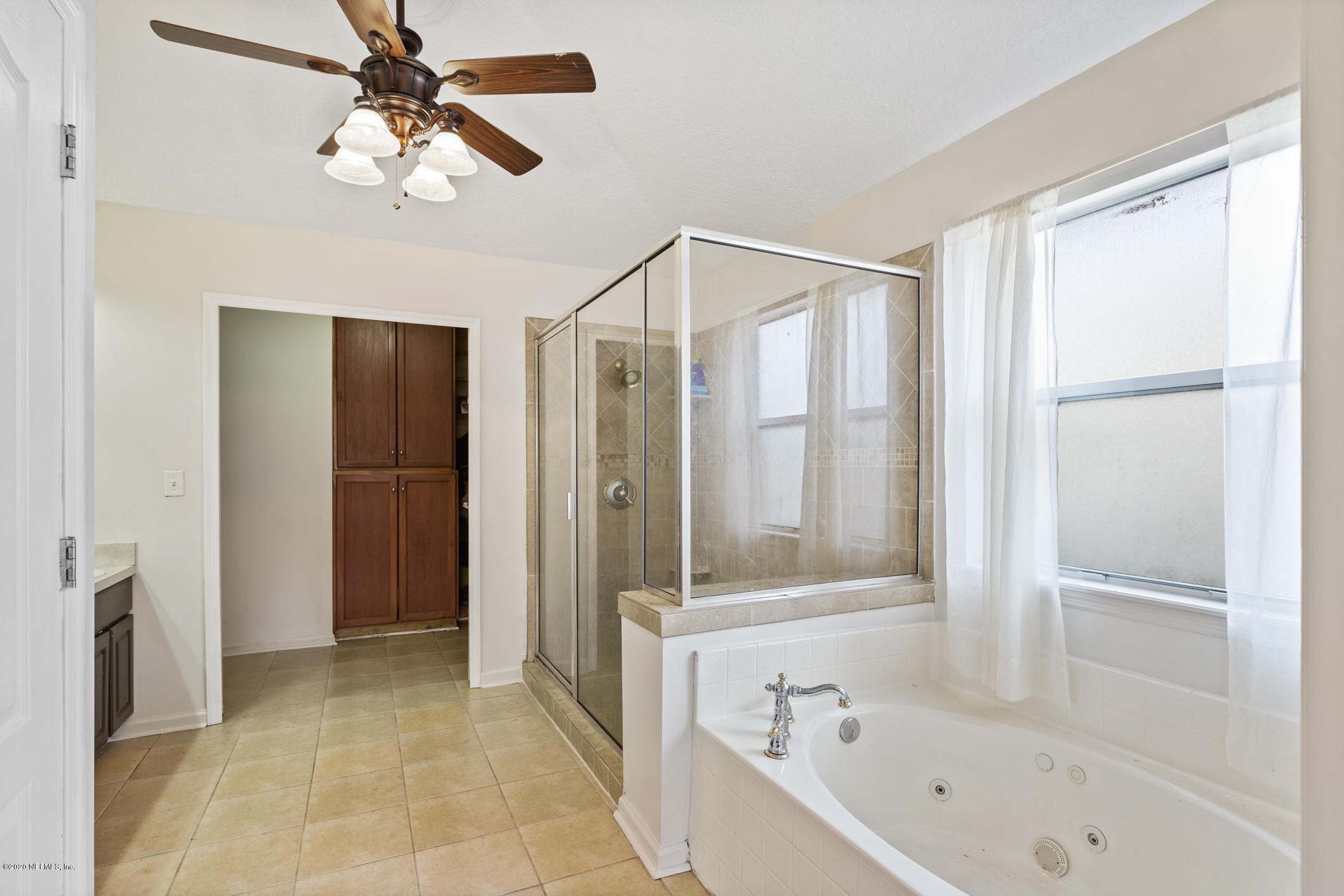 8145 Leafcrest Drive Jacksonville, FL 32244 - Photo 14 of 25 a bathroom with a bathtub and a shower