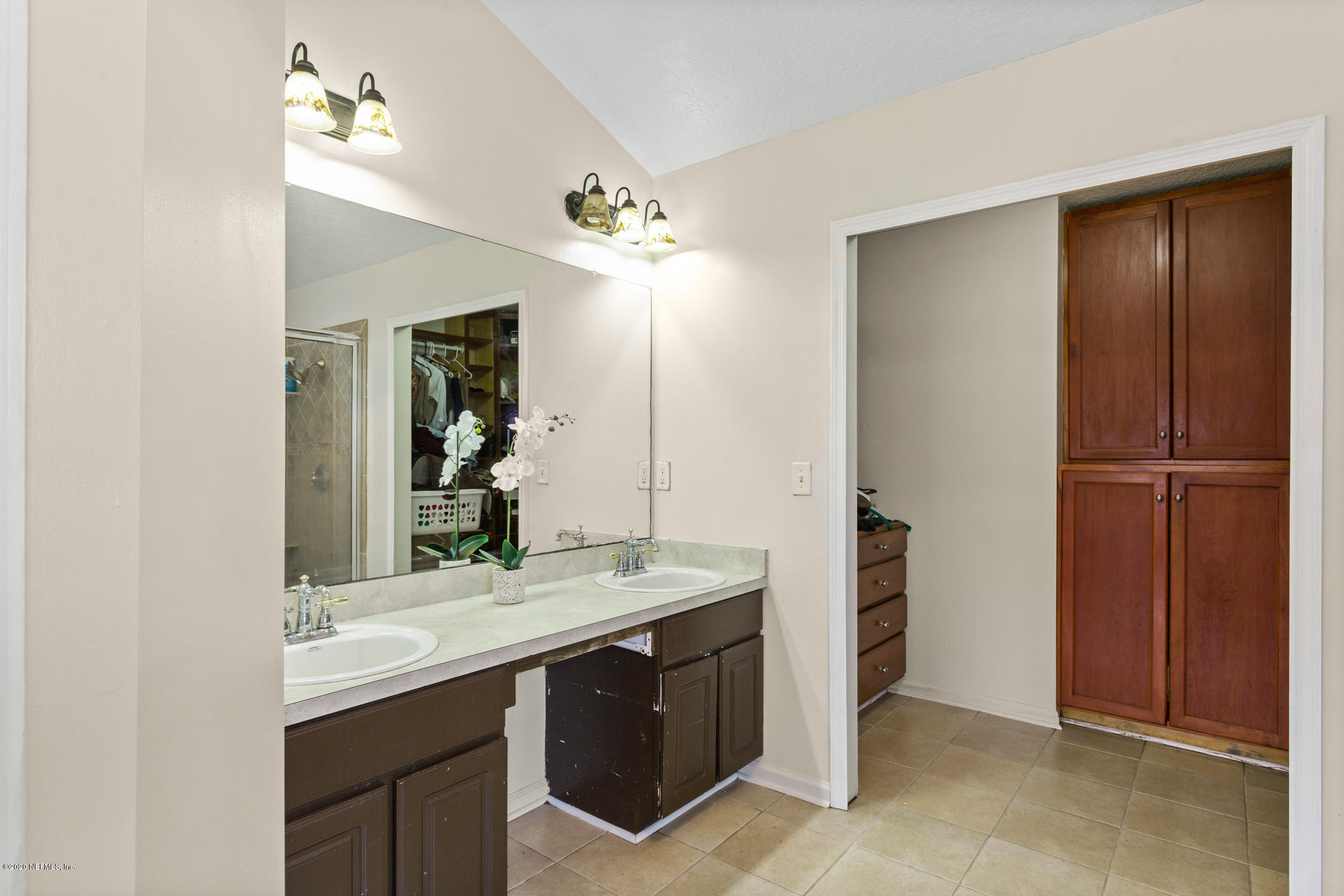 8145 Leafcrest Drive Jacksonville, FL 32244 - Photo 15 of 25 a bathroom with a double vanity sink and a mirror