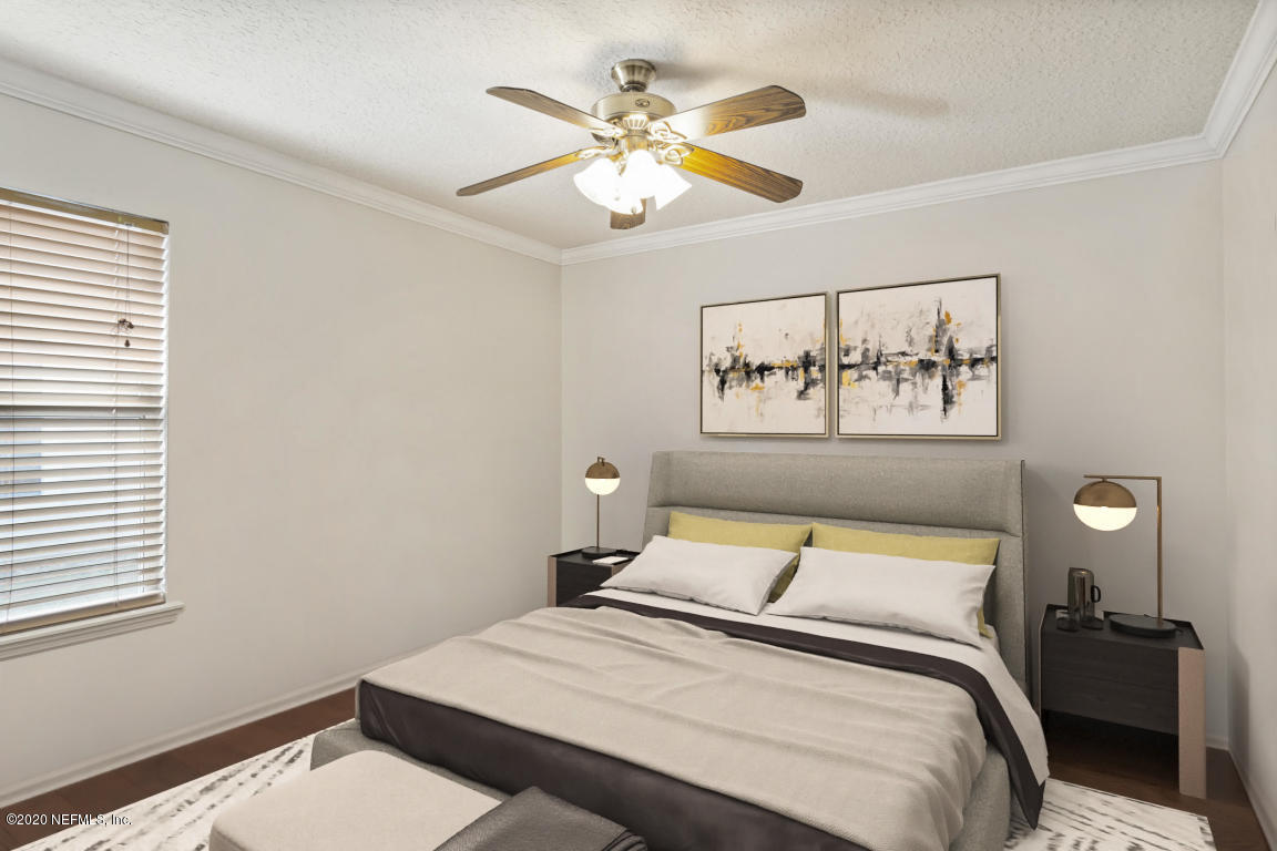 8145 Leafcrest Drive Jacksonville, FL 32244 - Photo 16 of 25 a bedroom with a bed and a painting on the wall