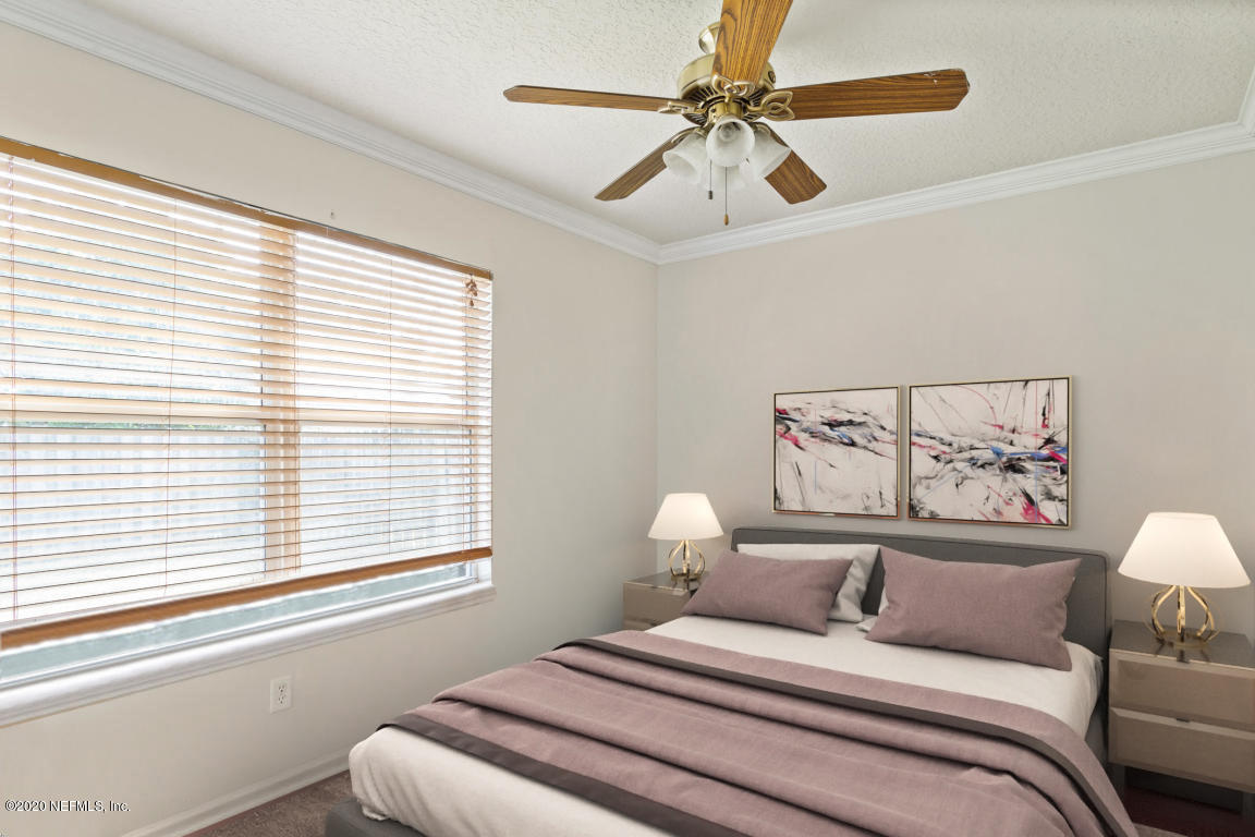 8145 Leafcrest Drive Jacksonville, FL 32244 - Photo 18 of 25 a bedroom with a large bed and a window