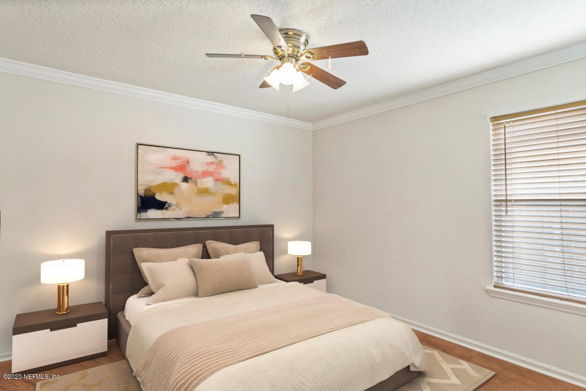 8145 Leafcrest Drive Jacksonville, FL 32244 - Photo 19 of 25 a bedroom with bed and painting on the wall