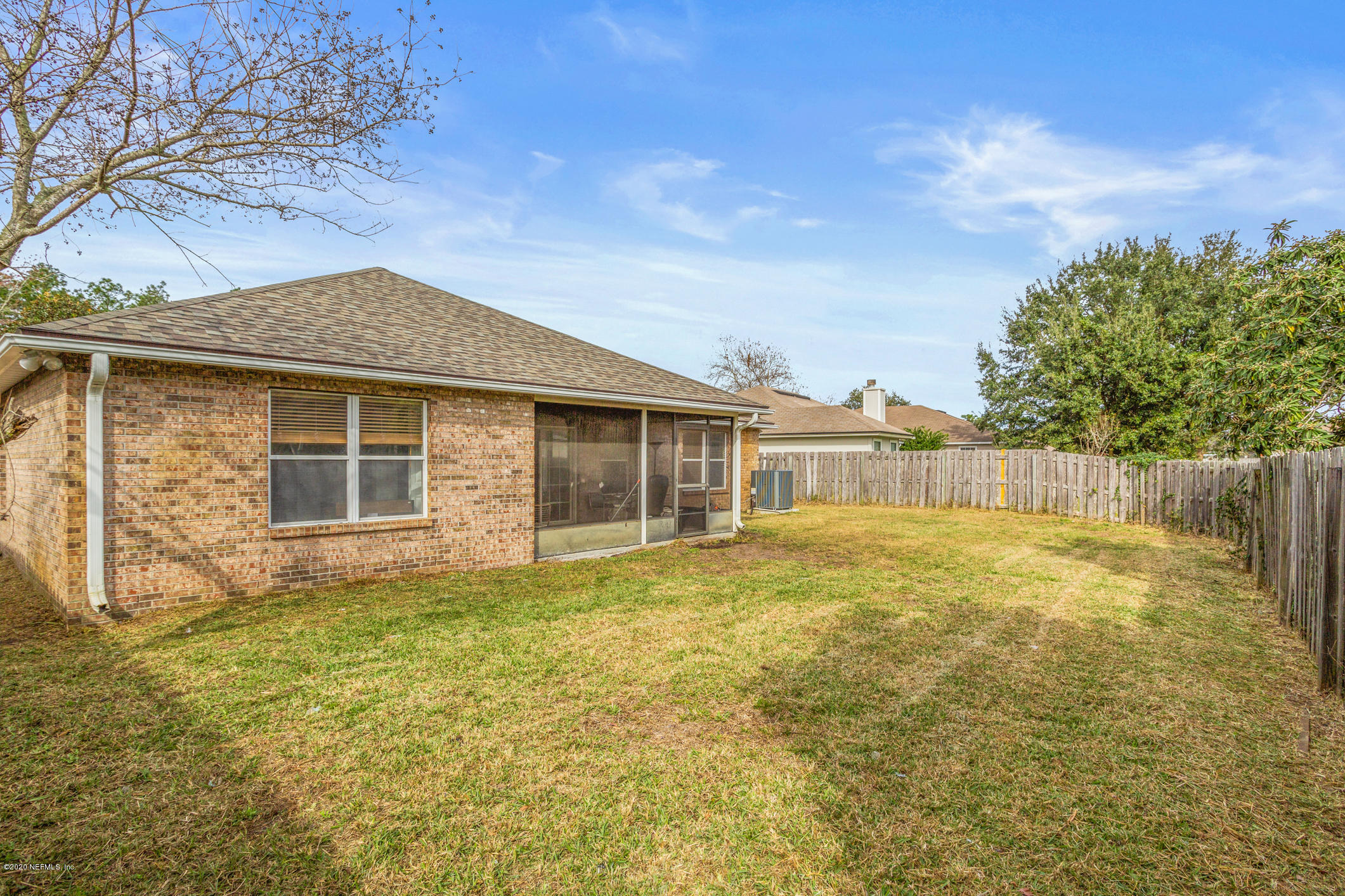 8145 Leafcrest Drive Jacksonville, FL 32244 - Photo 23 of 25 a view of a house with a backyard and a tree