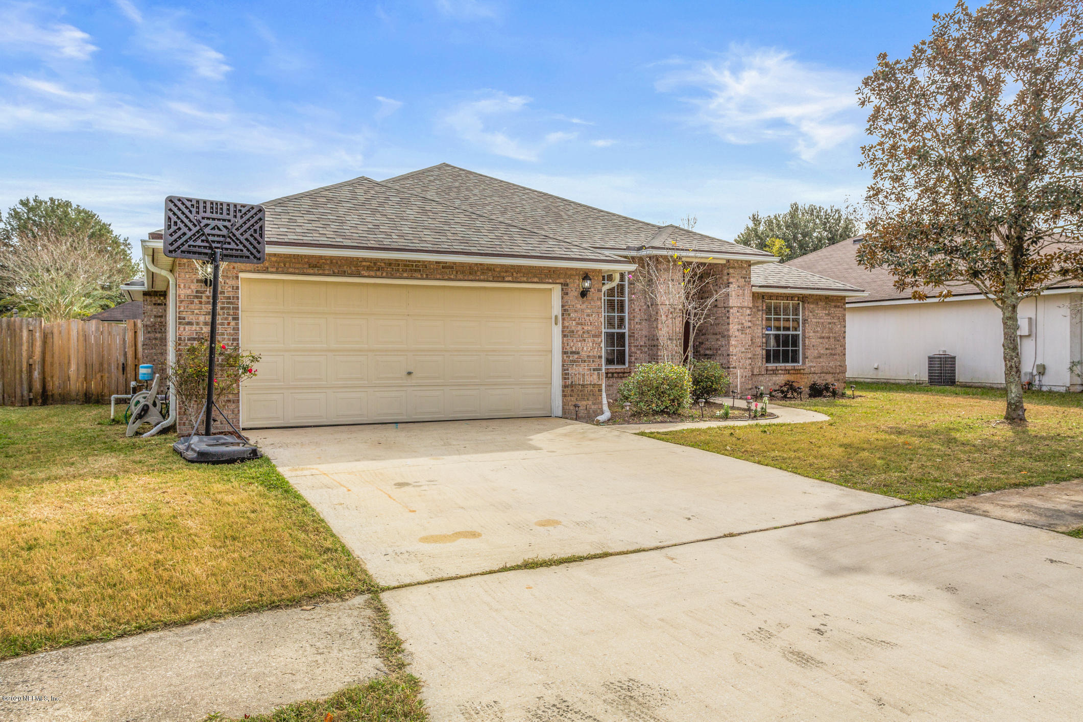 8145 Leafcrest Drive Jacksonville, FL 32244 - Photo 3 of 25 a front view of a house with a yard and garage