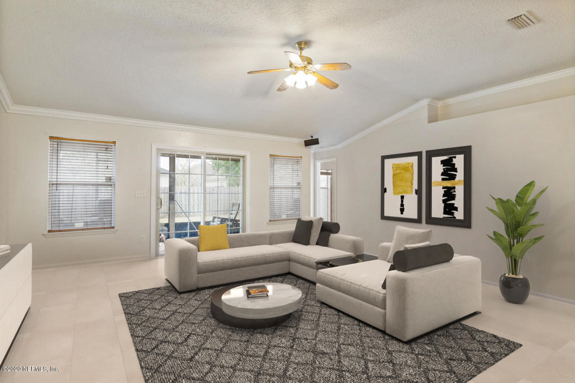 8145 Leafcrest Drive Jacksonville, FL 32244 - Photo 7 of 25 a living room with furniture and a large window