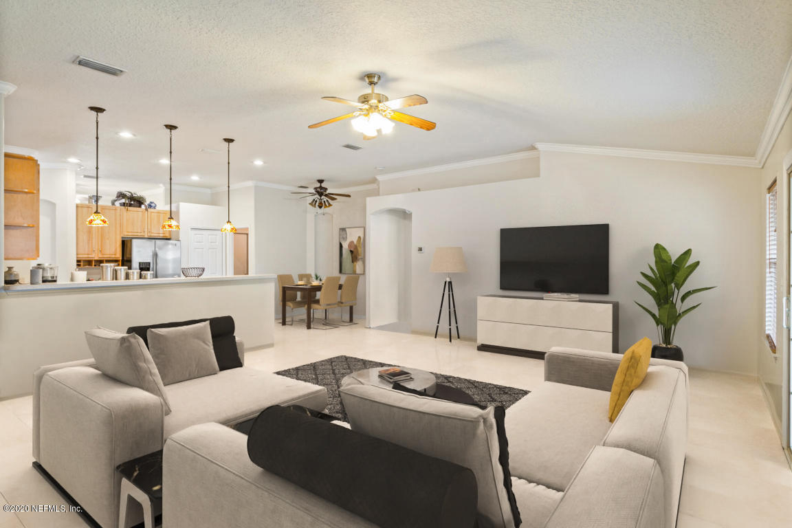 8145 Leafcrest Drive Jacksonville, FL 32244 - Photo 8 of 25 a living room with furniture and a flat screen tv