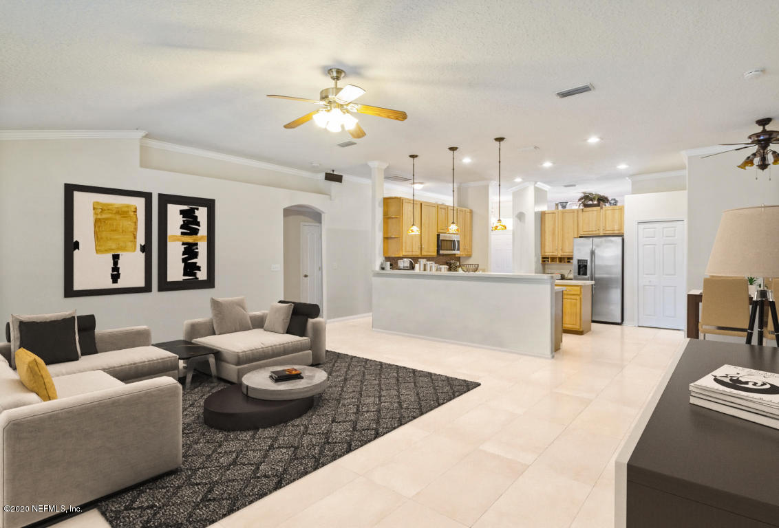 8145 Leafcrest Drive Jacksonville, FL 32244 - Photo 9 of 25 a living room with furniture kitchen view and a wooden floor