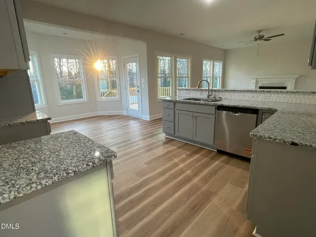 a kitchen with stainless steel appliances granite countertop a sink and a stove