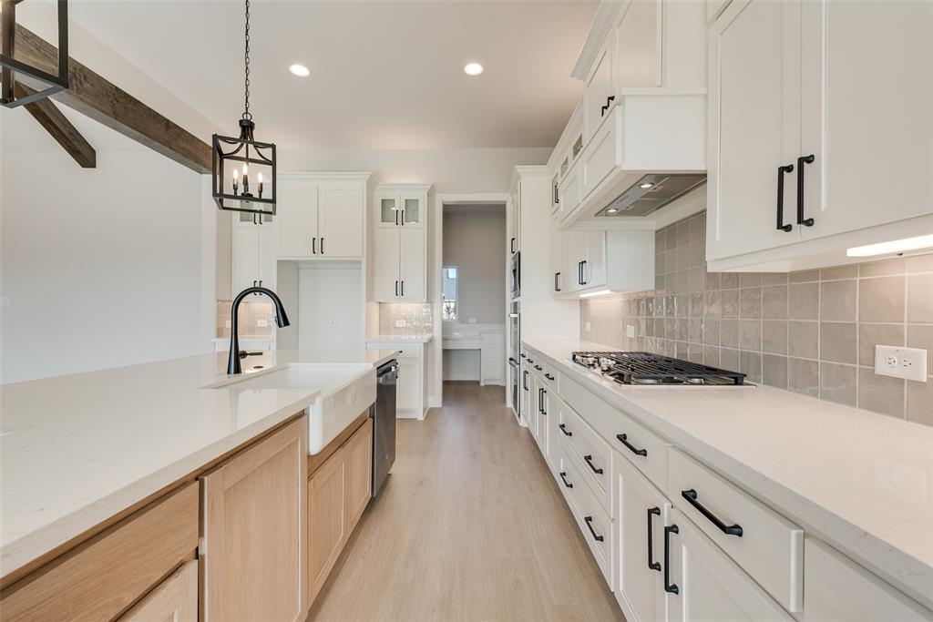 5291 Sunset Road Caddo Mills, TX 75135 - Photo 15 of 39 a kitchen with granite countertop a sink and a stove top oven