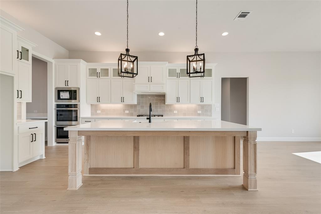5291 Sunset Road Caddo Mills, TX 75135 - Photo 16 of 39 a large white kitchen with stainless steel appliances kitchen island granite countertop a sink and cabinets