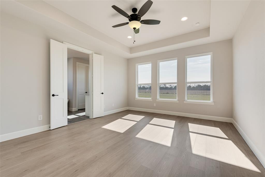 5291 Sunset Road Caddo Mills, TX 75135 - Photo 26 of 39 a view of an empty room with a window and a ceiling fan