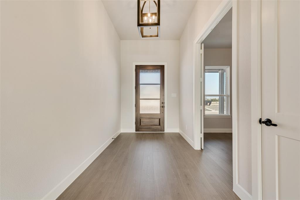 5291 Sunset Road Caddo Mills, TX 75135 - Photo 5 of 39 a view of a hallway with wooden floor and closet