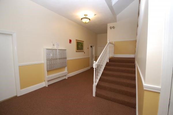 506 Beacon Street, Unit 13 Boston, MA 02215 - Photo 5 of 5 a view of entryway and hall with wooden floor