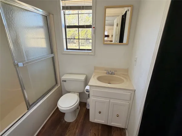 a white toilet sitting next to a bathroom sink