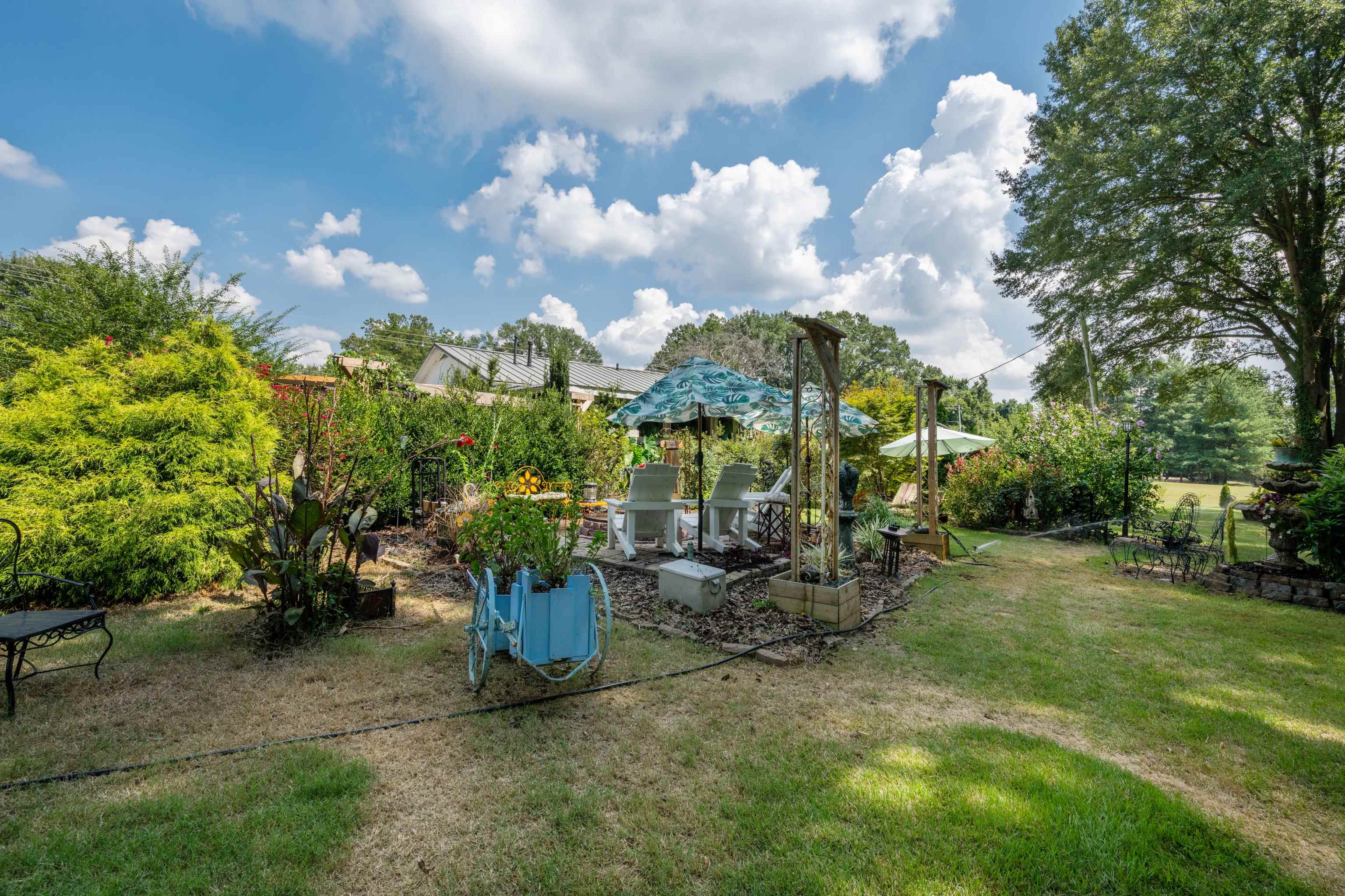 5921 Benjestown Road Memphis, TN 38127 - Photo 31 of 36 View of grassy yard featuring a patio area