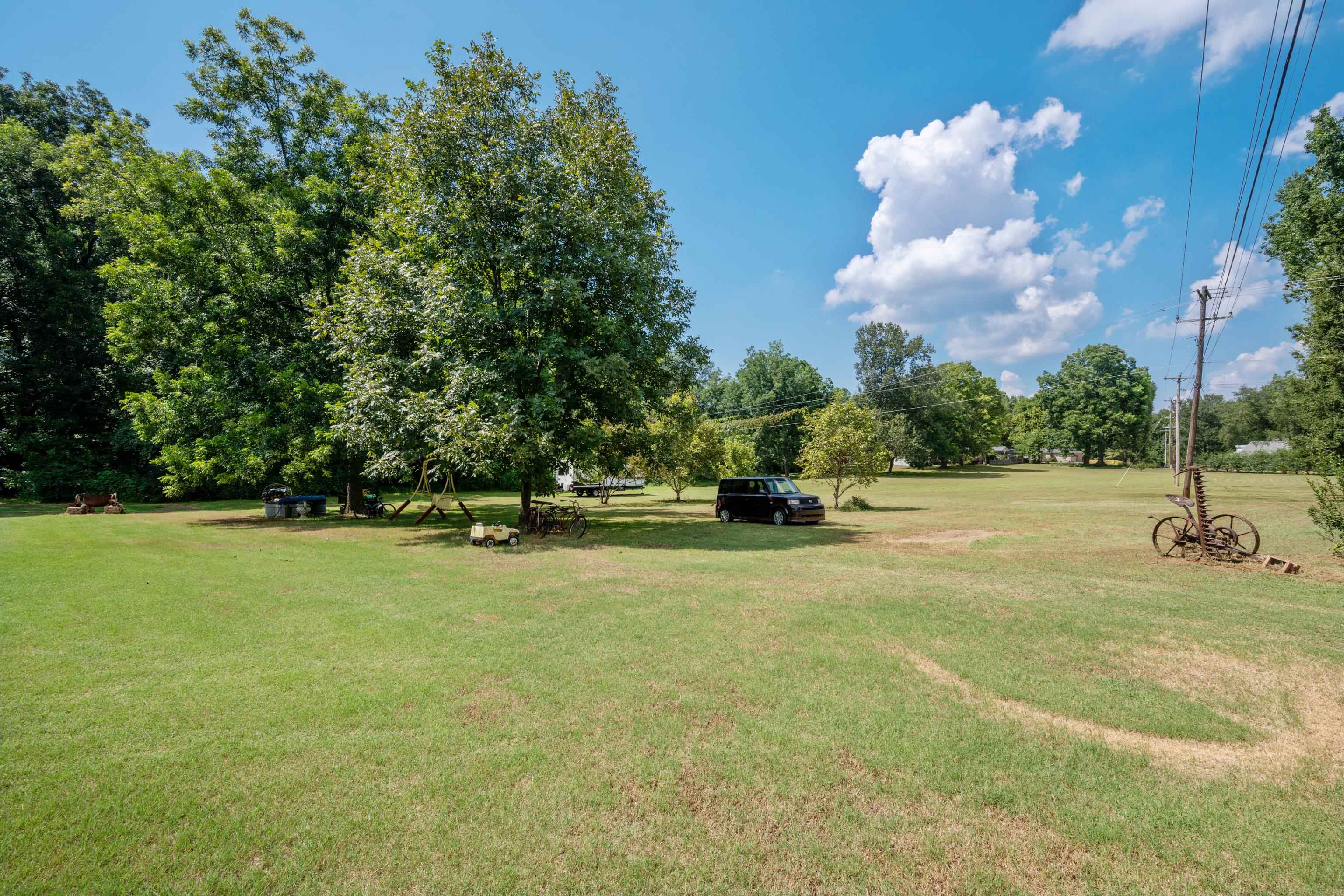 5921 Benjestown Road Memphis, TN 38127 - Photo 33 of 36 View of community featuring a yard and view of wooded area