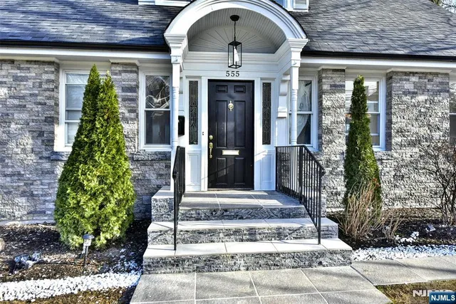 a front view of a house with garden