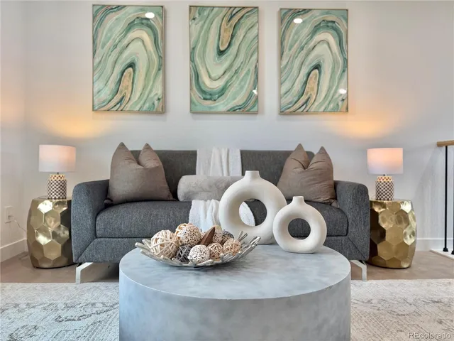 a living room with furniture and painting on wall