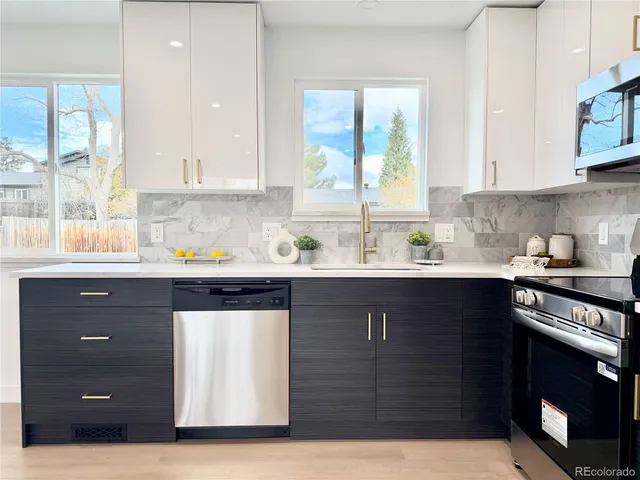 a kitchen with a sink a stove and window