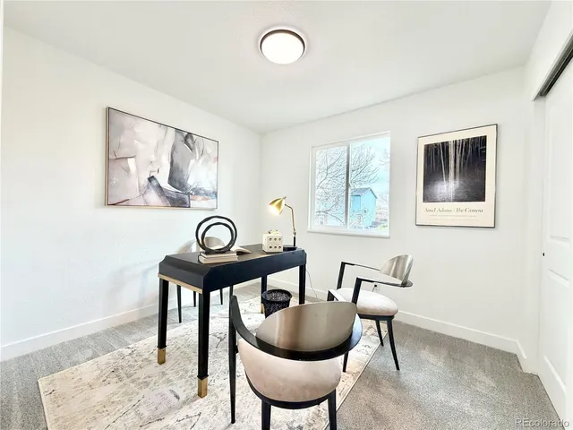 a living room with furniture and a wall painting