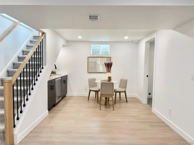 a view of a dining room with furniture and wooden floor