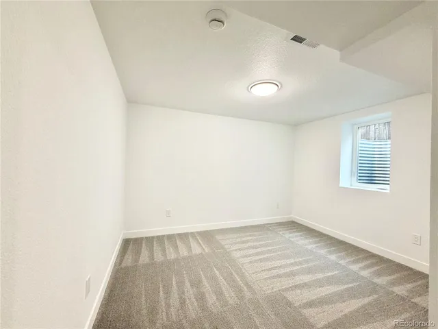 a view of hallway with a window and a dresser