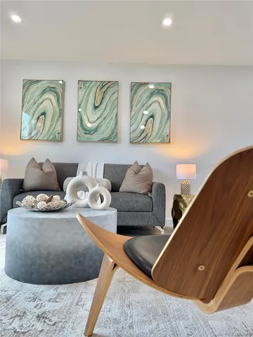 a living room with furniture and wall paintings