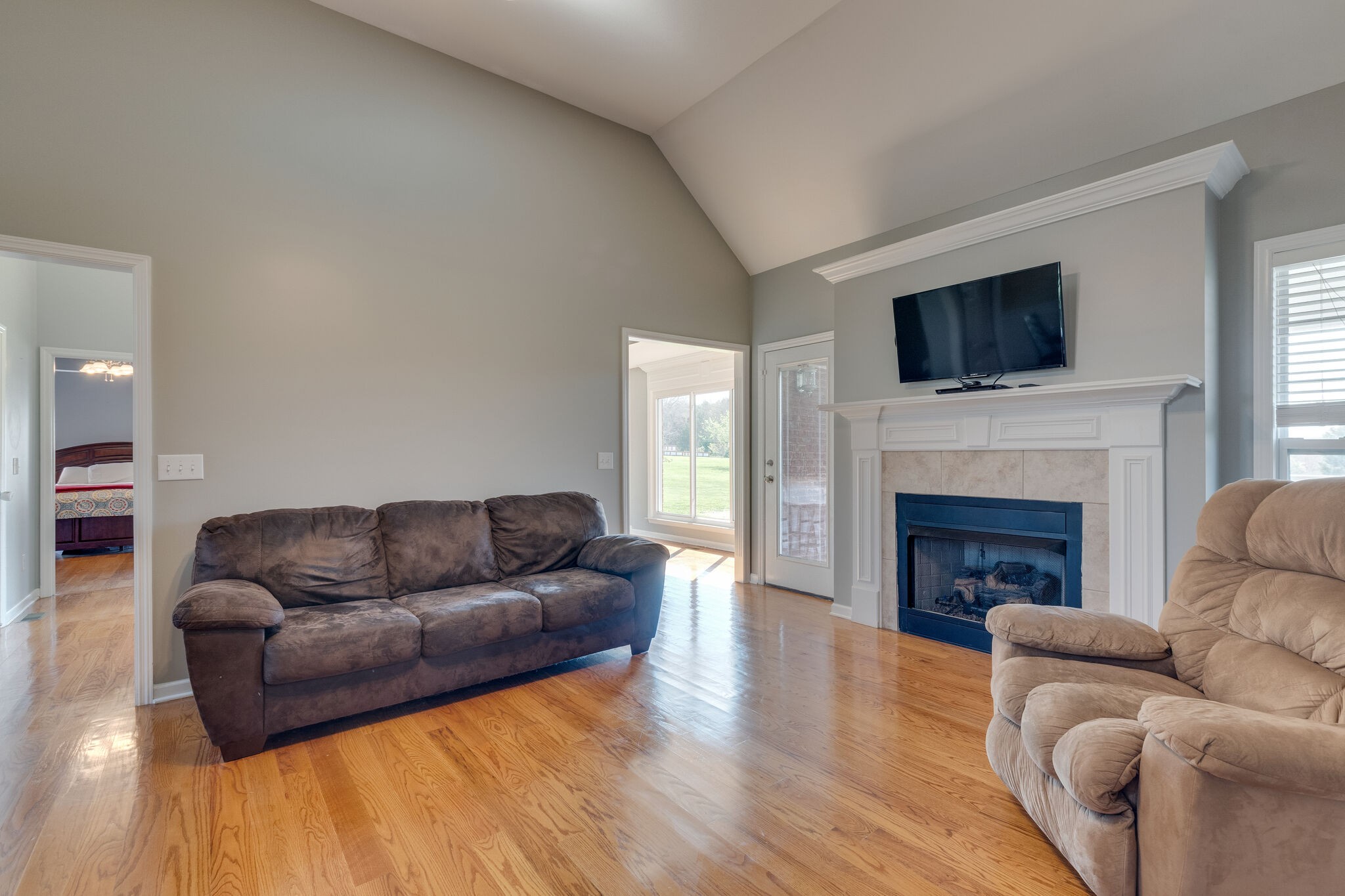 1978 Lasea Road Spring Hill, TN 37174 - Photo 11 of 31 a living room with furniture flat screen tv and a fireplace