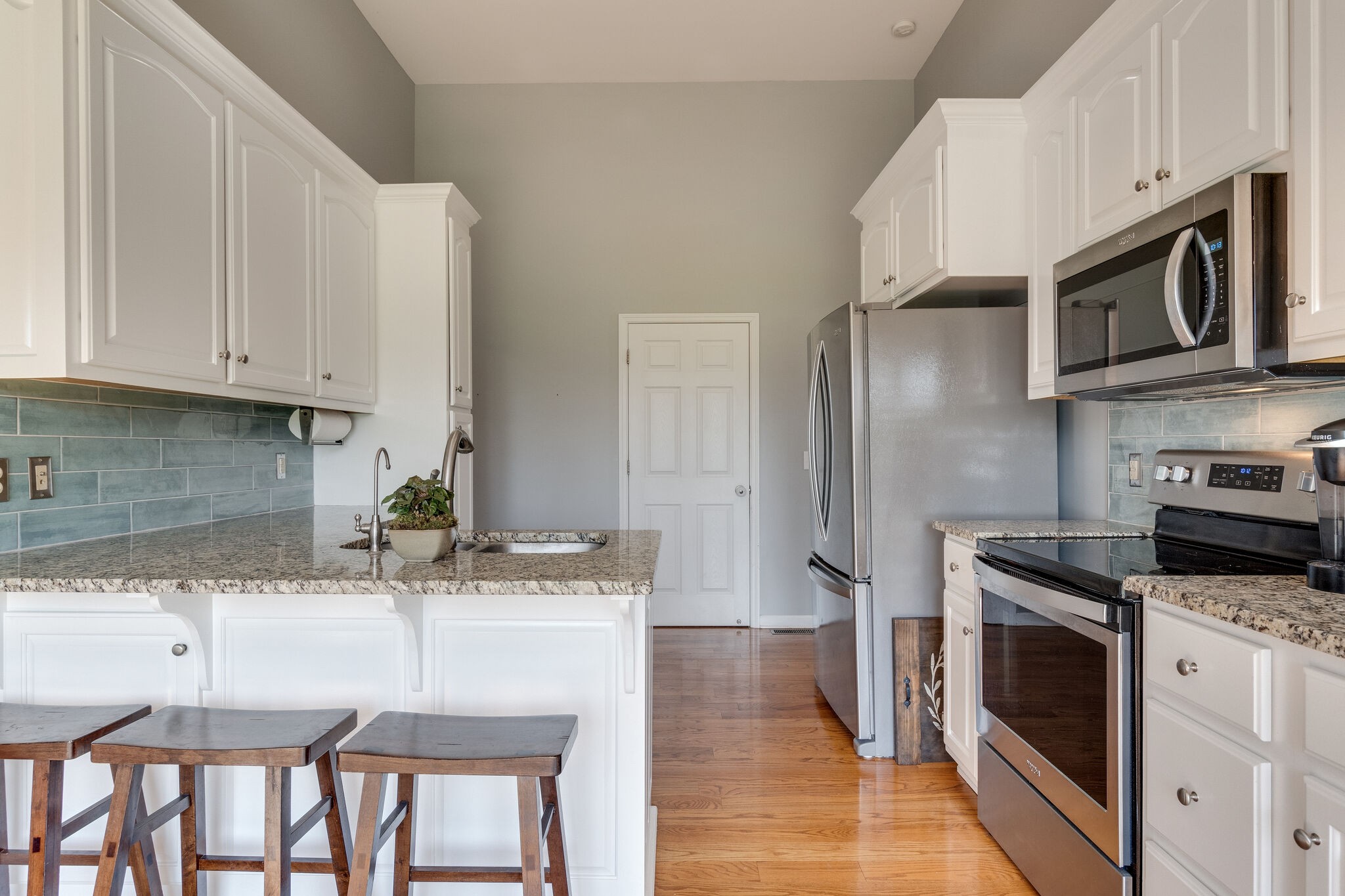 1978 Lasea Road Spring Hill, TN 37174 - Photo 17 of 31 a kitchen with stainless steel appliances granite countertop a stove a sink and a refrigerator
