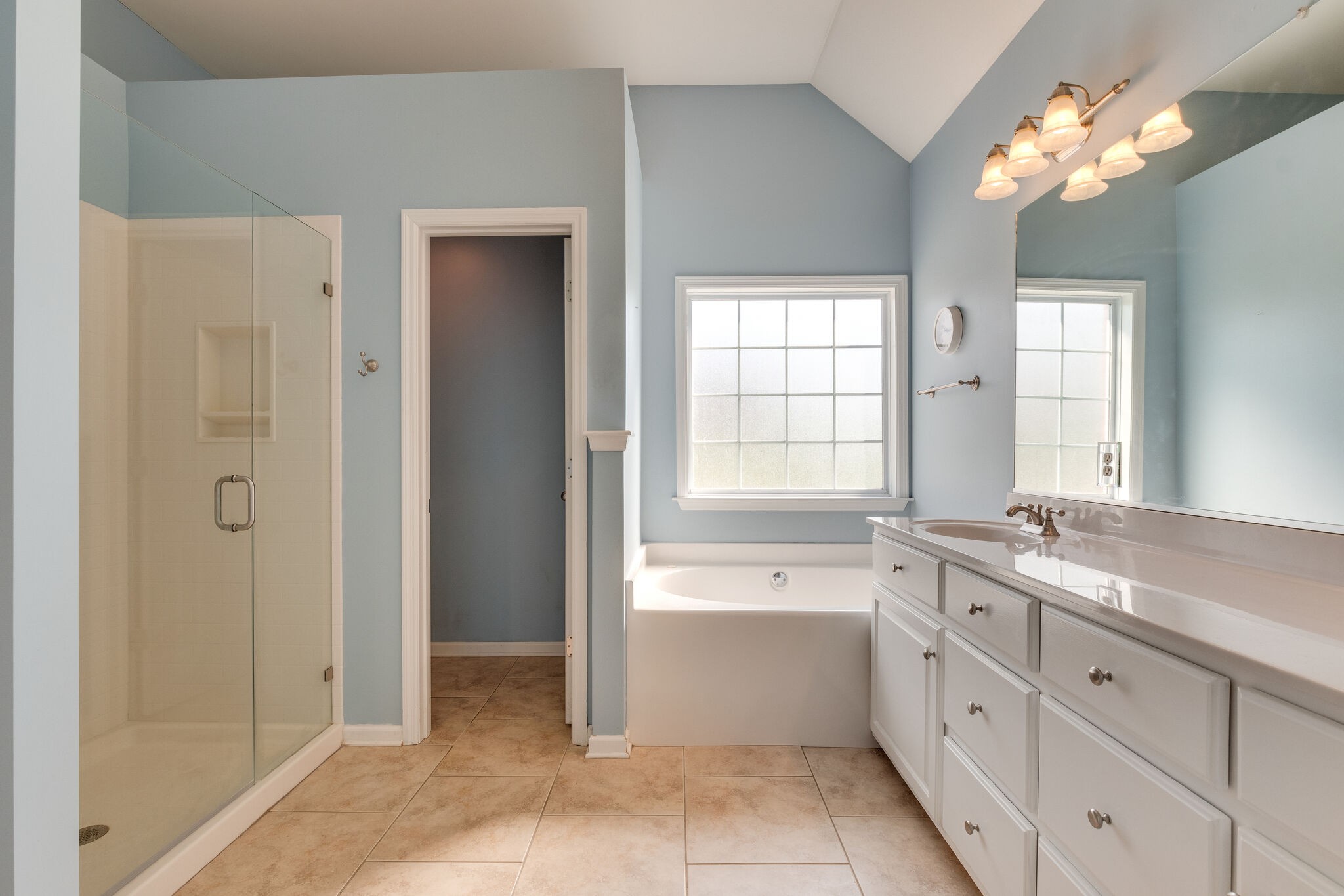 1978 Lasea Road Spring Hill, TN 37174 - Photo 20 of 31 a spacious bathroom with a double vanity sink a large mirror and a bathtub
