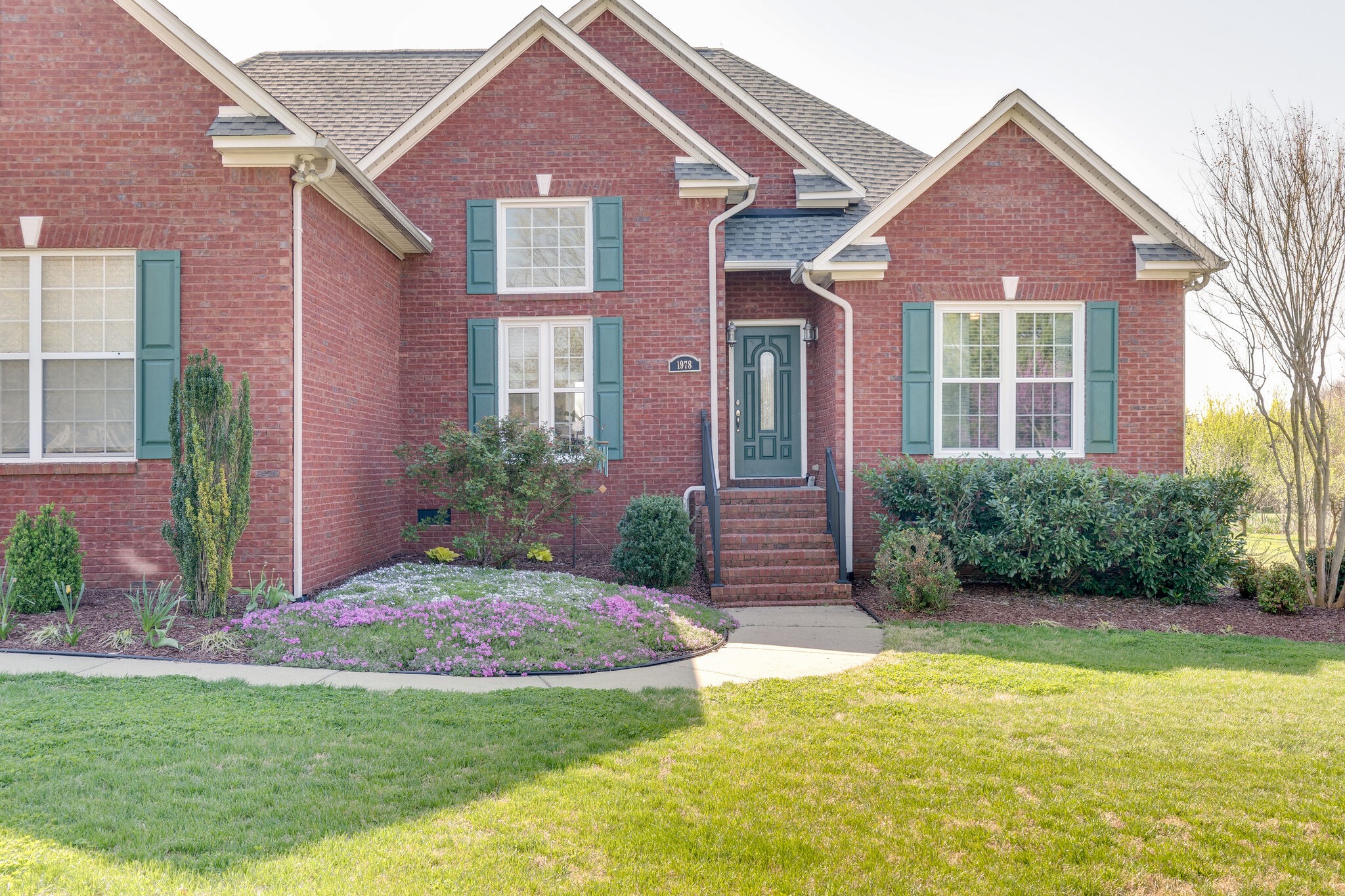 1978 Lasea Road Spring Hill, TN 37174 - Photo 4 of 31 a front view of a house with garden