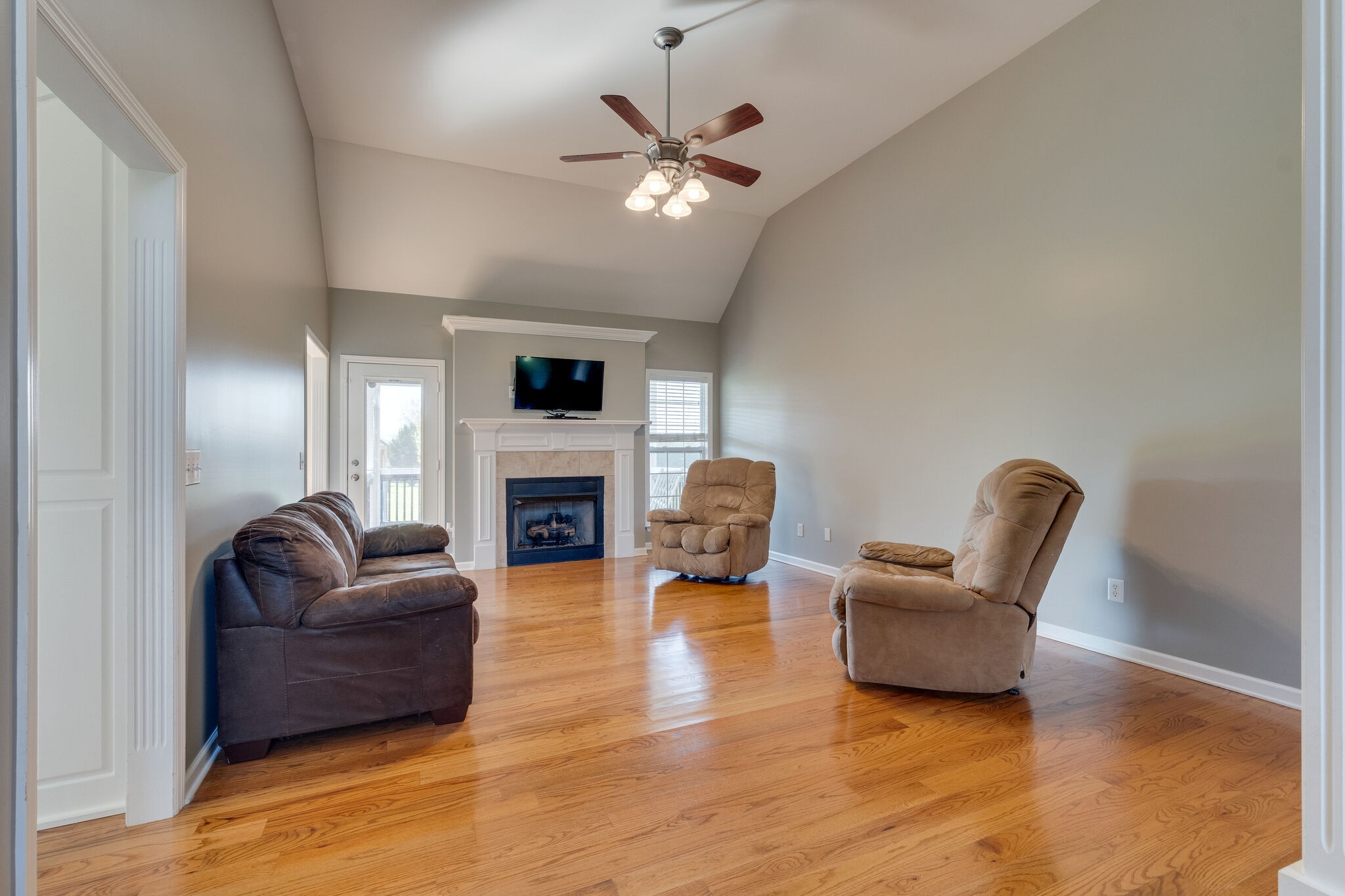 1978 Lasea Road Spring Hill, TN 37174 - Photo 9 of 31 a living room with furniture a fireplace and a flat screen tv
