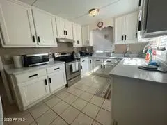 a kitchen with stainless steel appliances granite countertop a sink stove and cabinets