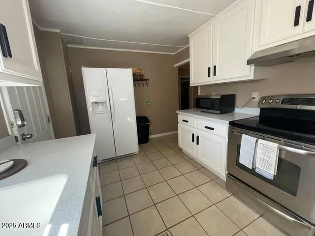 a kitchen with stainless steel appliances a stove a microwave and a refrigerator