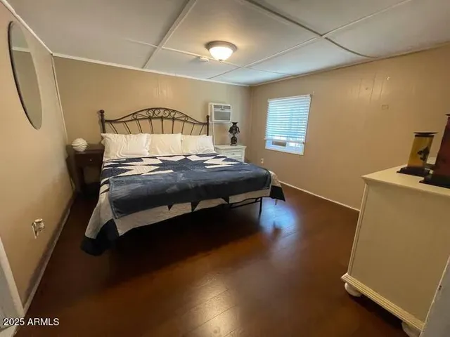 a bedroom with a bed and a desk