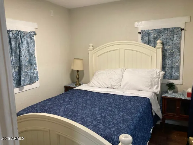 a bedroom with a bed and a mirror
