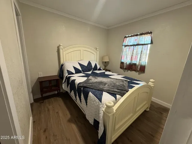 a bed sitting in a bedroom next to a window