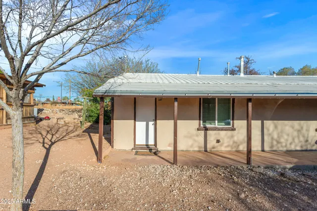 a view of a house with a yard covered in snow