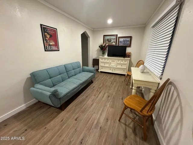 a living room with furniture and a wooden floor