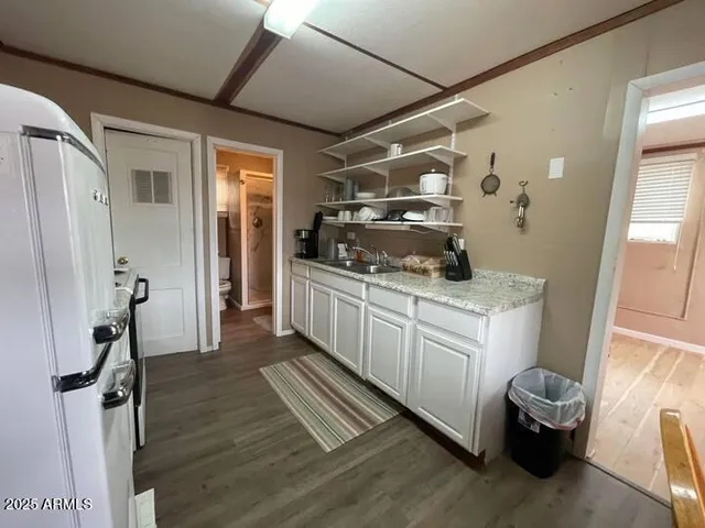 a kitchen with a refrigerator and a sink