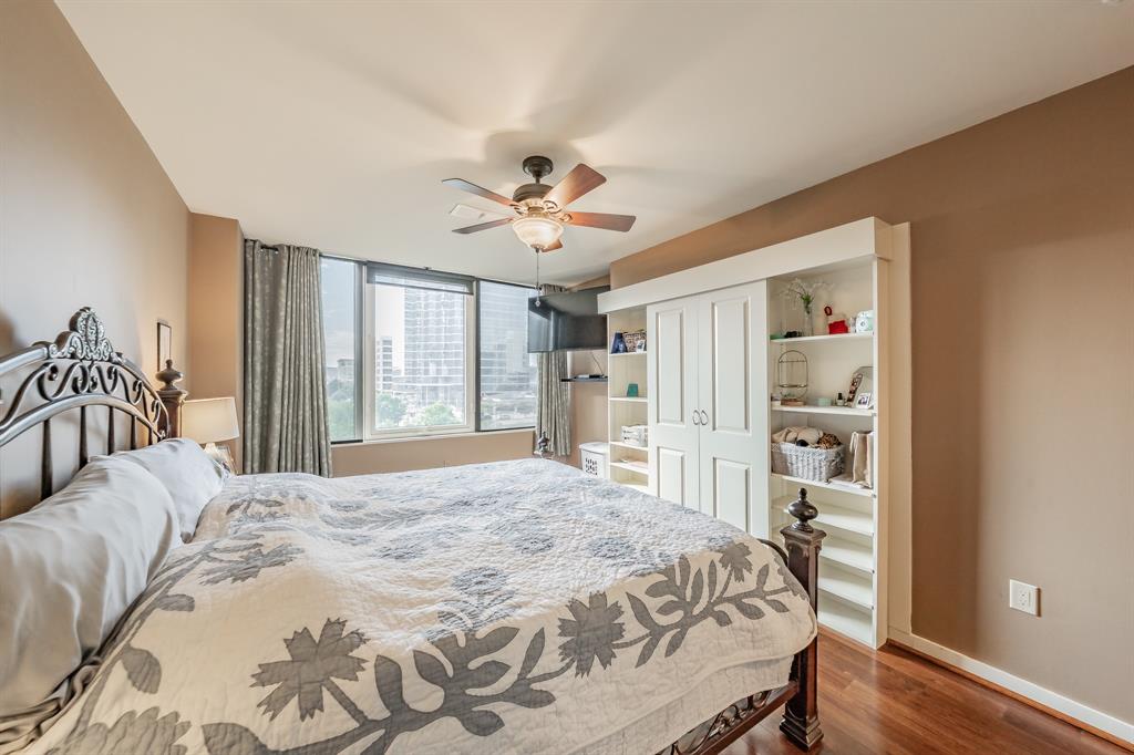 1200 Main Street, Unit 306 Dallas, TX 75202 - Photo 18 of 35 a bedroom with a large bed a chandelier and a window