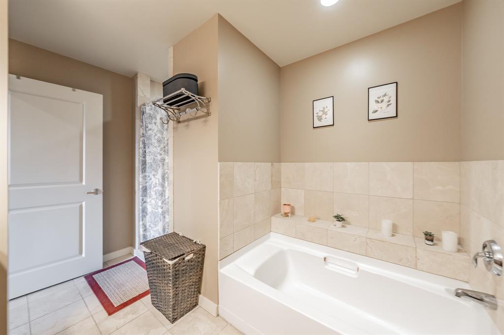 1200 Main Street, Unit 306 Dallas, TX 75202 - Photo 20 of 35 a bathroom with a tub and a shower