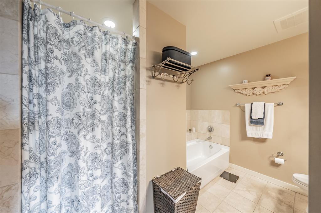 1200 Main Street, Unit 306 Dallas, TX 75202 - Photo 22 of 35 a bathroom with a sink toilet and shower